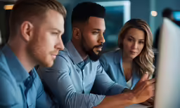 two employees with computers are discussing work