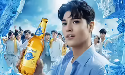 a young man holding an icey beer while surrounded by other men