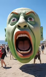 a large green alien head with open mouth in sand