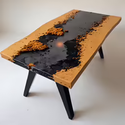 there is a black and orange table that has been placed on the ground