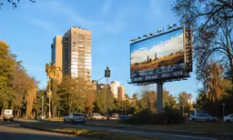 two city banners are on top of a signpost