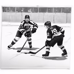 there is a male hockey player playing in black and white