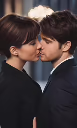 a man and woman kiss with a chandelier