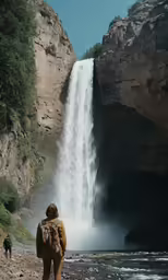 a person walking up the side of a large waterfall