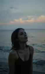 a woman looking up at the water