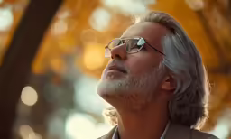 the man in the glasses has a grey beard