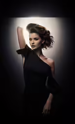 a beautiful woman in a black dress posing