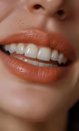 a woman with orange lipstick on her lips