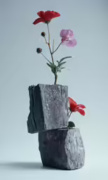 an artistic vase with a flower on top of it