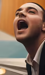 a man in a suit opening his mouth