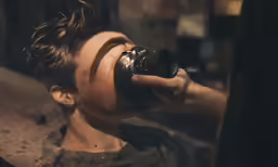 a woman drinking a beverage from a cup