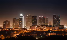 view of skyscrapers from a city skyline at night