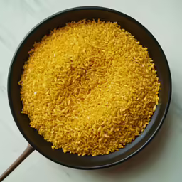a black bowl filled with yellow rice