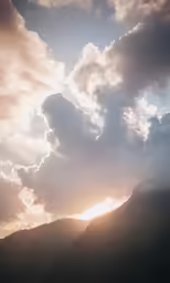 a beautiful shot of the setting sun over mountains