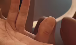 two people making a hand signal with their fingers