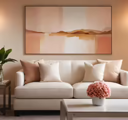 a white sofa and table in front of a painting