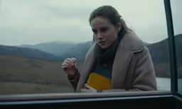 there is a woman that is looking in the mirror