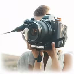 a man that is holding a camera with a flash