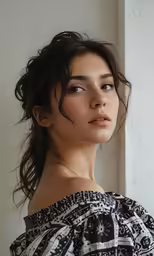 a woman in a dress looks off to the side