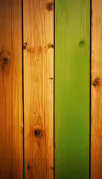 close up of a green wooden fence with wood boards,wood panels with green and yellow paint showing the colors of the boards