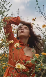 a beautiful woman standing next to some yellow flowers