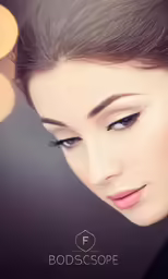 a woman with a sleek make - up wearing pearls and a pearl necklace