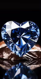 a heart shaped blue diamond sitting on top of a table