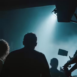 a dark stage with a man in the spotlight