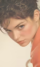 the woman has very curly hair and her eyes are not open
