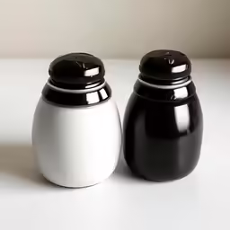 two black and white jars side by side