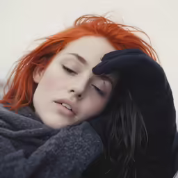 the red haired woman is covering her face with her hands