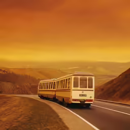 a long bus that is sitting on the side of the road