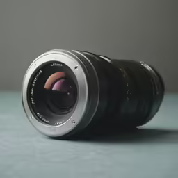 a zoom lens laying on top of a blue surface