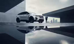 a man standing beside his white car outside