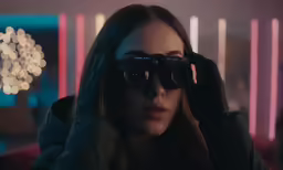 a woman looks through some large binoculars