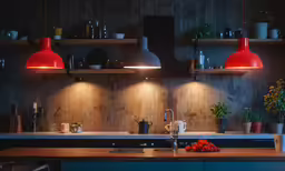 a kitchen with large and small lights hanging over the stovetop