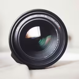 a camera lens sitting on a table in close up