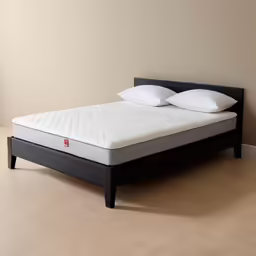 a mattress is on the corner of a room