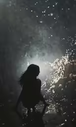 a silhouetted woman in water, with fireworks in the background