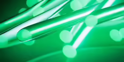 three long white straws in green and white