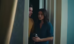 an attractive couple in their apartment looking at each other