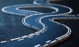 there is an empty asphalt road and curve on it