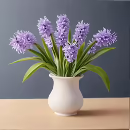 a white vase filled with lots of purple flowers