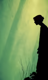 a man stands in front of the sun