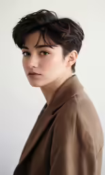 the young woman in a coat is wearing blue eye lashes