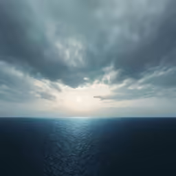 the sun shining in clouds over the ocean