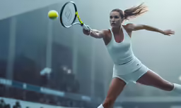 a woman swinging a tennis racquet at a ball