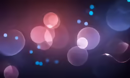 an abstract blurry background of pink and blue lights
