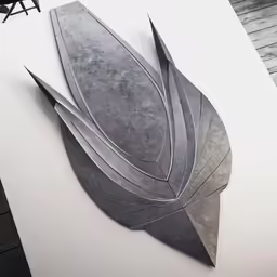 a sculpture made out of metal on top of a table