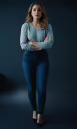 a beautiful young woman standing in front of a dark background